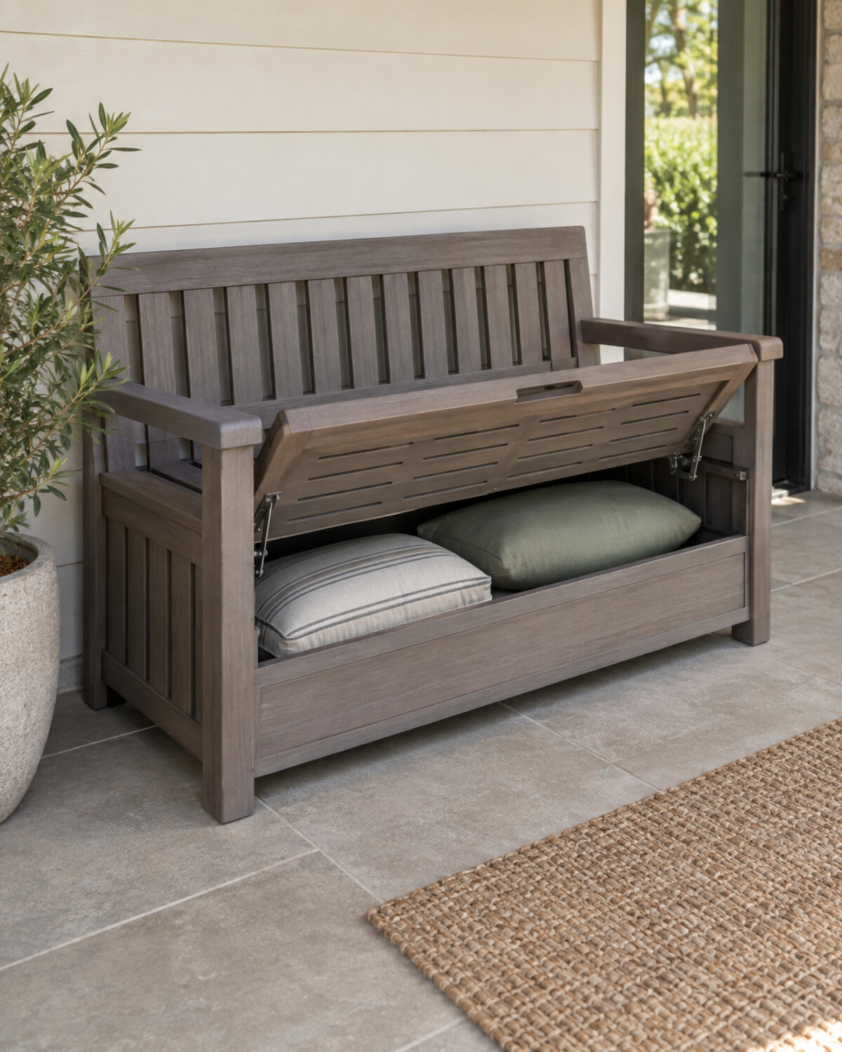 Built-in-look patio seat with a slatted ventilated compartment holding neatly folded outdoor cushions